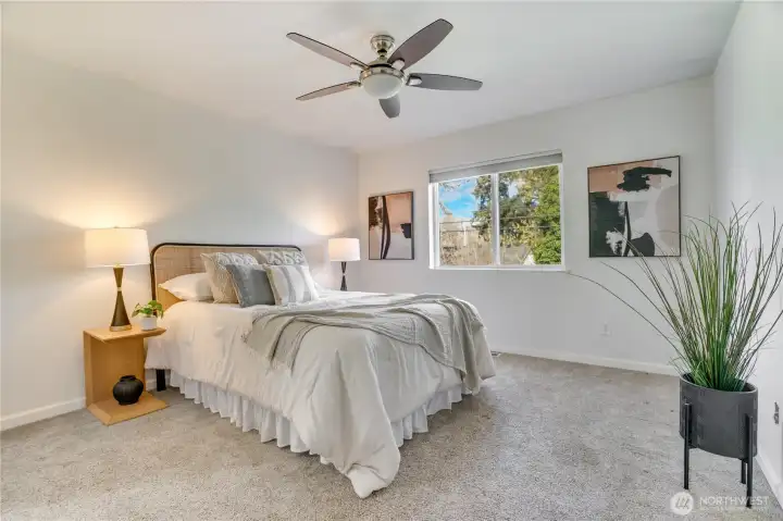 Freshly painted primary is roomy enough for your King bed and dressers.