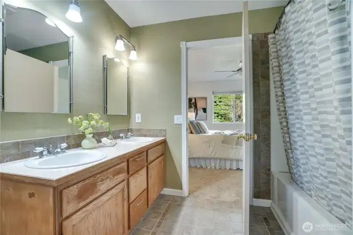 Dual vanity and soaking tub with shower, and a separate water closet.