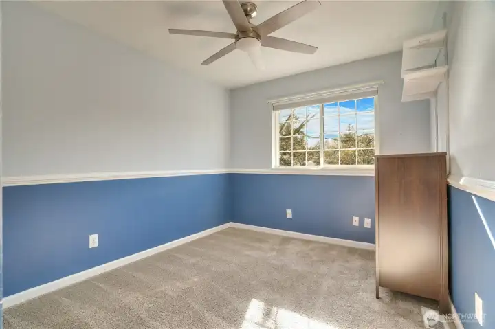 Bedroom #2 with closet shelving and ceiling fan.