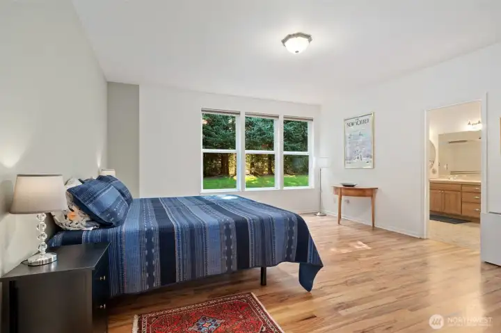 Huge Primary bedroom with ensuite bath. Look at those gorgeous wood floors!