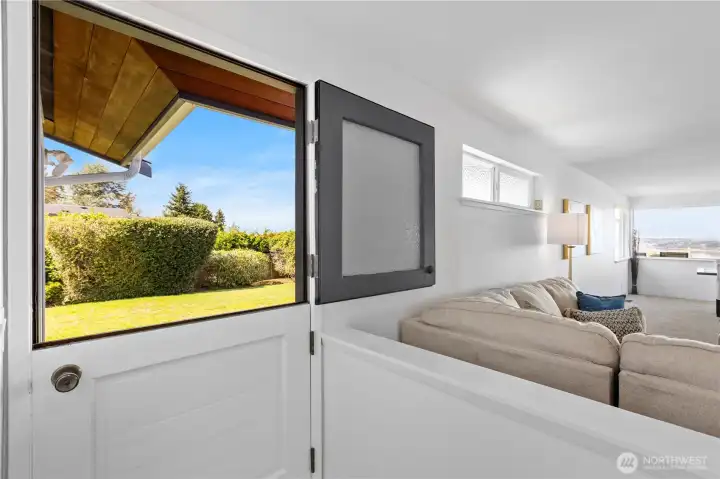 Dutch door with obscure glass leads to back deck