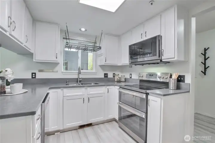 Upgraded kitchen with stainless appliances and refaced cabinetry