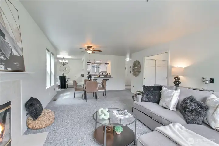 living and dining room with fireplace and door to patio