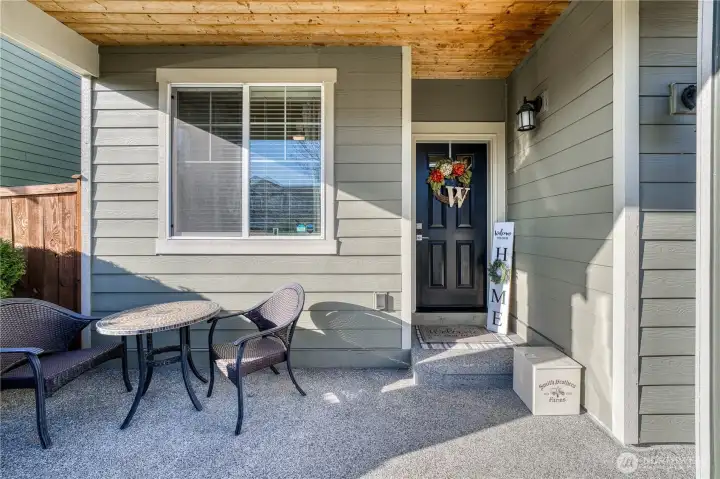 Welcoming front porch with tounge and groove pine ceiling.