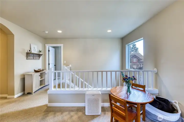 Landing at the top of the stairs is flooded with natural light.