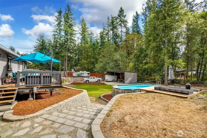 Walkway to rear yard, pool and deck.