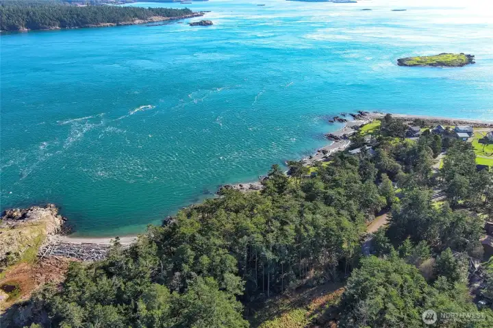 Aerial perspective highlights the stunning waterfront setting of Cape San Juan, surrounded by forest, shoreline, and sparkling island waters.