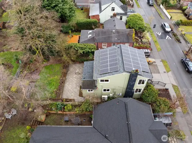 Aerial view of the home, solar panels and backyard.