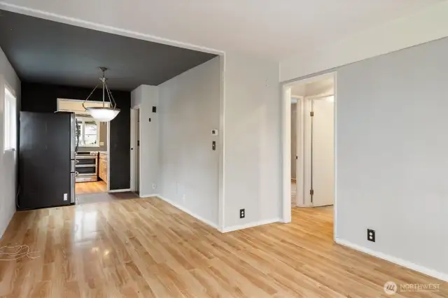 View of dining room and hallway to main floor bedroom and full bath in hallway