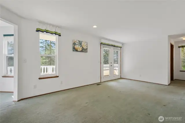 Primary bedroom upstairs. Full of windows and its own deck.