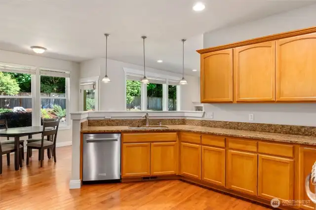 Look at all of this counter space! Slab granite counters with undermount sink, stainless appliances