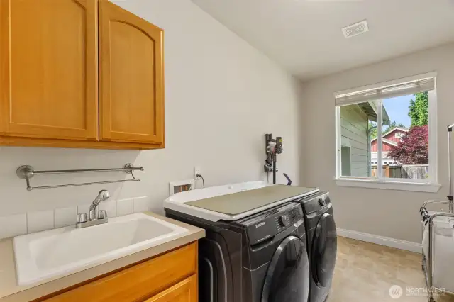Check out this terrific laundry room! Complete with utility sink and space for coats and shoes (it is right off the garage). Washer and dryer are included in the sale