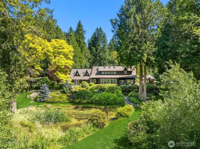 The charming main home sits above the pond, and offers lovely views of the pond and gardens out its many windows.