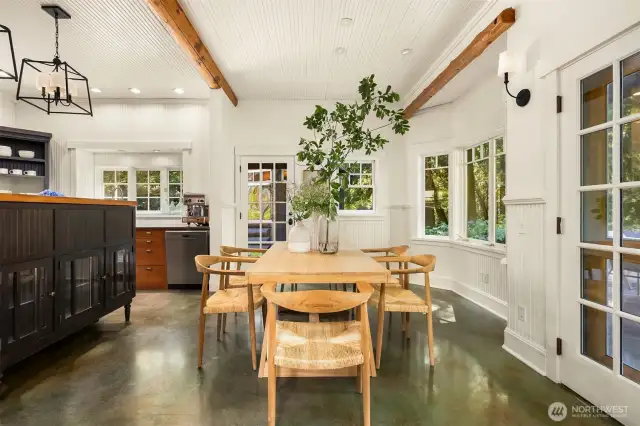 The large dining area cozies-up to the kitchen, but is separated by beautiful handmade glass-front cabinetry, lighted to display cherished items. The door straight ahead offers access to the large wrap-around patios and a fun gazebo housing a wood-fired pizza oven. French doors spill out to a covered area overlooking the grounds and pond.