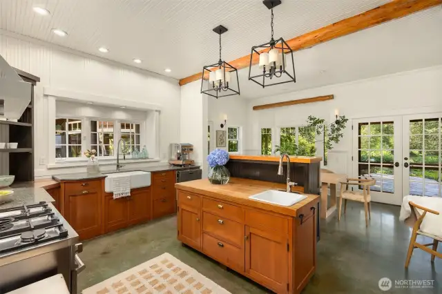 The kitchen was designed to work for people who love to cook and entertain. A large farm sink is complemented by a veggie sink and chopping block prep counter. Both of these work spaces offer lovely views of the grounds.