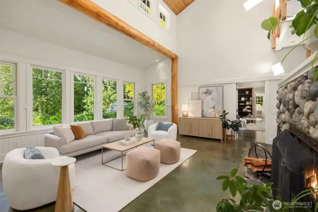 This view of the living room faces the primary suite, with the study/library seen through the open doorway.
