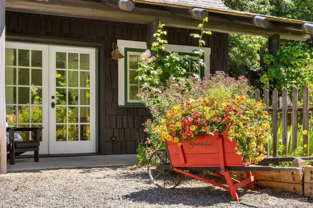 The studio space is graced by yet another covered patio, and is adjacent to a cottage-style herb and flower garden awaiting the next lucky owner’s additions where the rich soil was not planted this year.