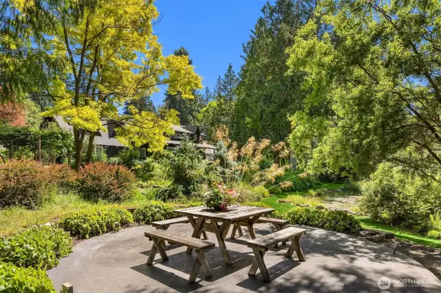 This pondside patio offers a different vantage of the pond and property. It once house a “glamping” tipi, with its adjacent outdoor bathroom (no longer in use, but it could be!).