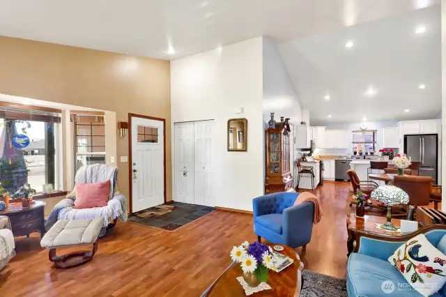 High vaulted ceilings above and laminate floors below just add to the appeal of this charming home!