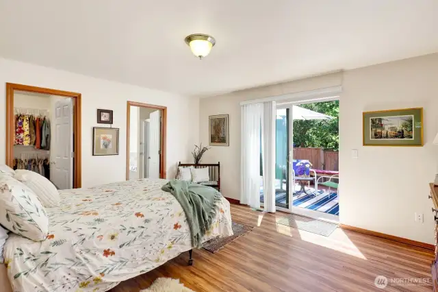 Retreat to the serene primary suite, complete with a  sliding glass door that opens directly to your own private deck, perfect for morning coffee or evening relaxation, overlooking the gorgeous backyard oasis.