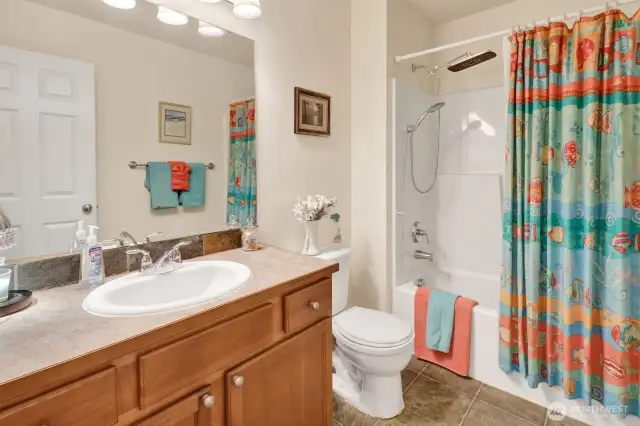This full bath includes a tub/shower combo with hand held rain head.