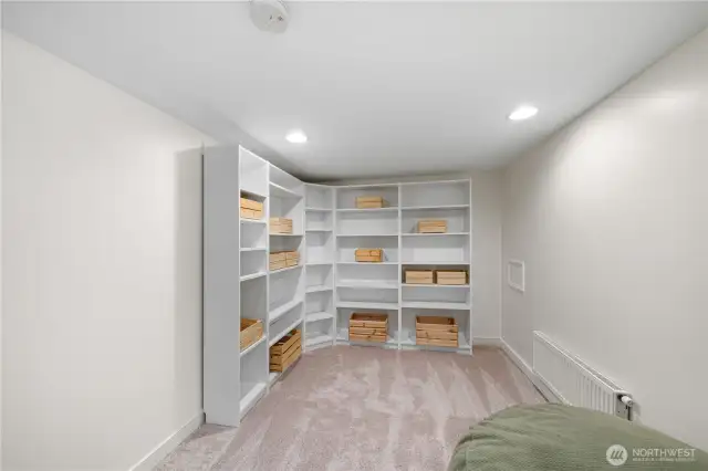 Additional bonus room in basement with shelving that stays with the home.
