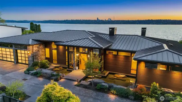Front exterior - showing standing seam metal roof and extensive, automated soffit lighting.