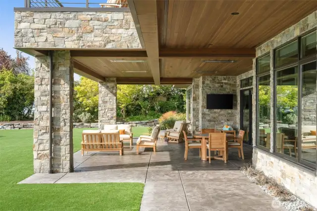 Lower level patio with entertaining space, AV and heaters. Custom VG fir lids showing the understated elegance of the home.