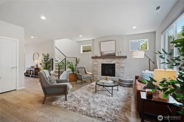 Gleaming LVP flooring glides you to this open great room accented with a grand stone surround gas fireplace that sits as the center piece in the living room, creating a cozy and comforting ambiance.