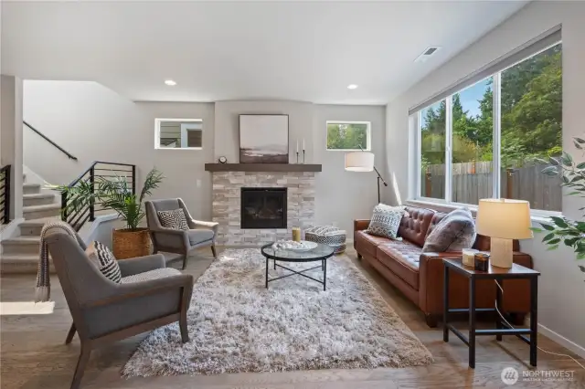 Dual walls of windows frame the living room to allow all the natural light to illuminate this inviting space. Hi-tech remote-controlled blinds allow you to seamlessly transition over to more privacy in the evenings.