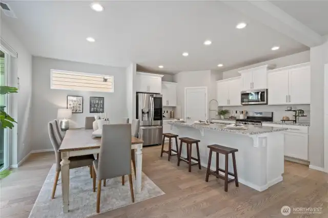 Chefs will delight in this dream kitchen with bar seating at the center island, sparkling granite countertops with full-height subway tiled backsplash, soft-close maple cabinetry, stainless steel appliances including a 5-burner gas range and French-door refrigerator and pantry.