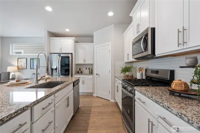 Indulge in culinary master pieces in this gourmet kitchen, thoughtfully designed to provide ample counter space, cabinetry storage and functional layout for ease of use from prepping station to the gas cooktop.