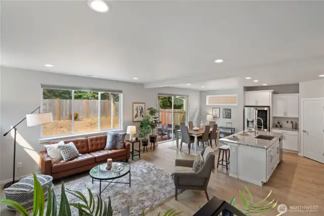 Striking features like the walls of windows, delightful gourmet kitchen, LVP flooring and abundant recessed lighting impress in this open concept great room. Open sight lines between the living, dining and kitchen allow for optimal entertaining while still maintaining distinct separation between the spaces.