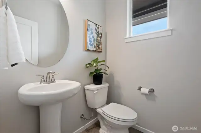 Convenient main floor powder room discreetly located right off the front entrance.