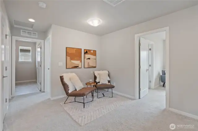 To the right of the loft area is the first bedroom and to the left of the loft area is the hallway to the other two bedrooms and utility room.