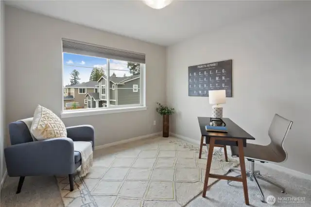 Bedroom #1 with its eastern exposure receives beautiful warm morning sunlight, a perfect space for a home office  or as a bedroom.