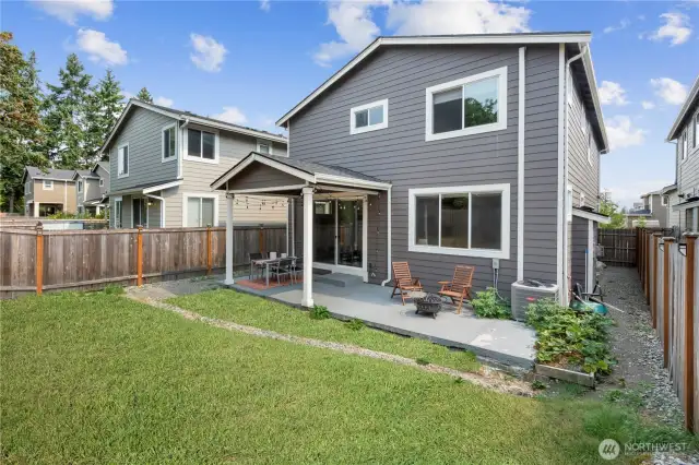 Step outside to the fully-fenced backyard with upgraded extended patio space for outdoor enjoyment. Home is equipped with A/C for year-round comfort. (Green lawn digitally enhanced)