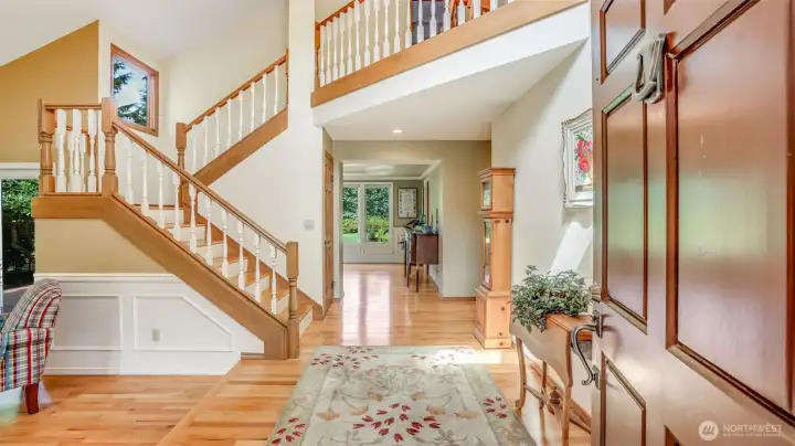 Beautifully designed foyer with hardwood floors and wainscoting, offering timeless finishes and a seamless flow into the heart of the home.