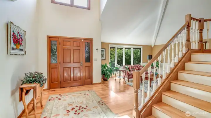 Step into a bright foyer with soaring cathedral ceilings and abundant natural light.