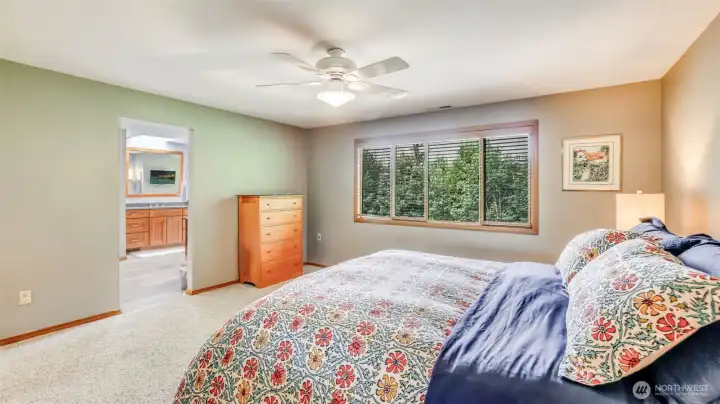 Relax in this peaceful primary sanctuary with warm finishes and a private ensuite.
