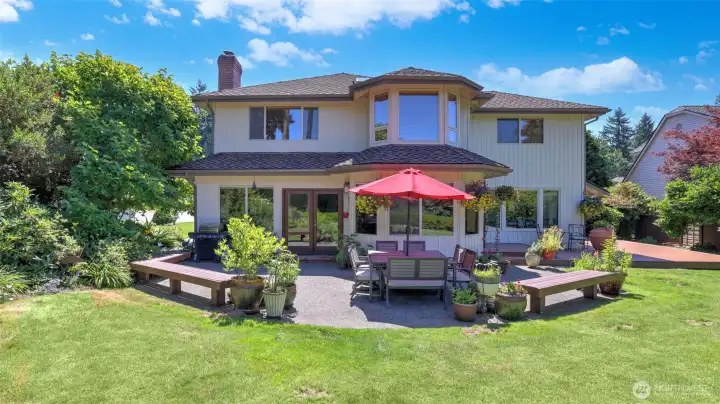 Private outdoor living space featuring a large patio and vibrant surroundings.