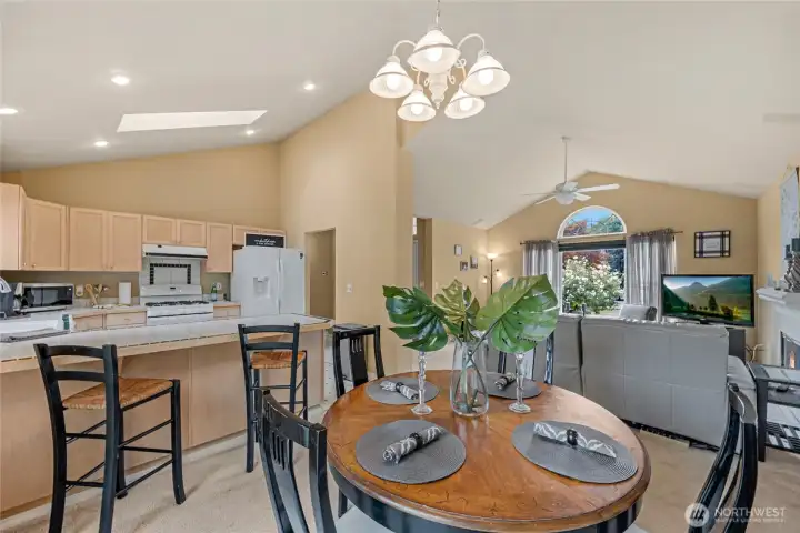 Open concept kitchen/dining/living space.