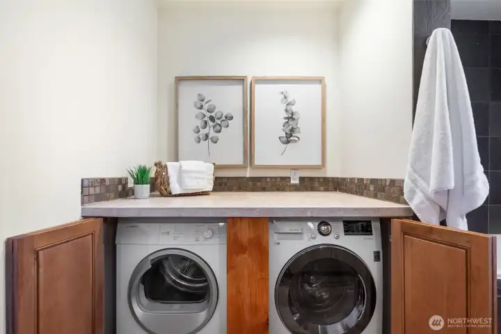 Side by side washer and dryer with folding and storage area
