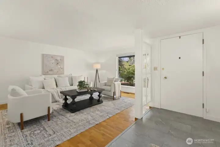 Spacious entryway opens to large living room.