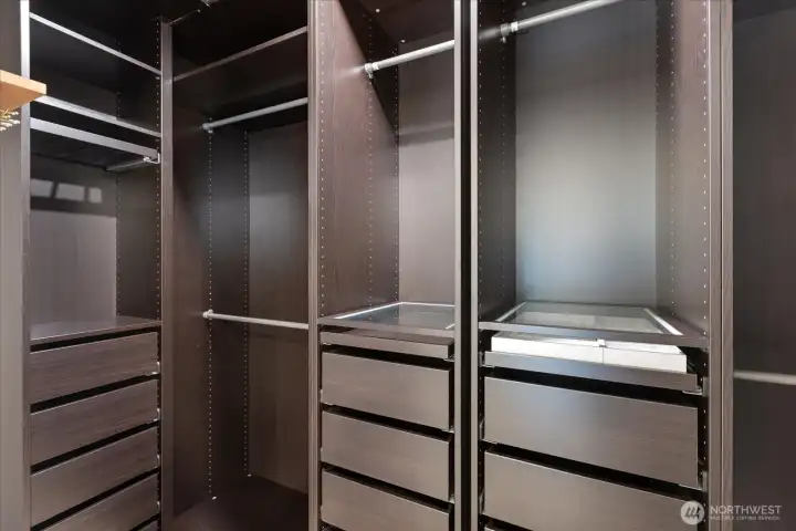 Walk-in closet has built-ins with soft close drawers.