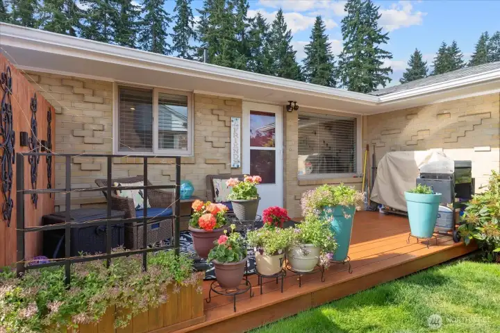 Private backyard deck surrounded by lush landscaping—perfect for relaxing or outdoor gatherings.
