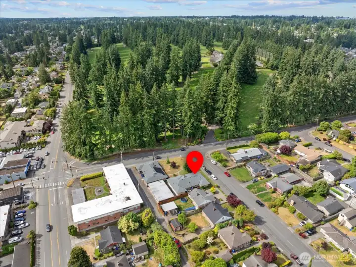 Expansive aerial view capturing the nearby tree-lined golf course and surrounding Everett neighborhood.