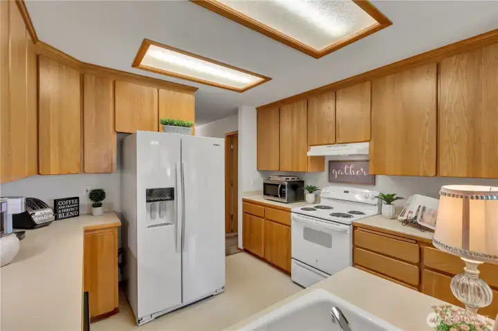 Kitchen has wonderful counter space and is cheerful with natural lighting