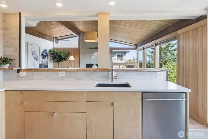 Newer cabinets, solid countertop and custom maple live-edge slab detail.
