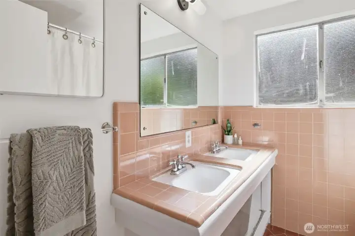 Original bathroom tile and slanted double vanity. Tile is in great shape.